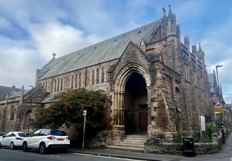 The exterior of St. Oswald's Centre — a Victorian Gothic stone church building with an ornate arched entrance, on Bruntsfield Place in Edinburgh